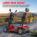 A Metro Mobility S500 Heavy Duty 4-Wheel Power Scooter, featuring sleek black accents and a comfy seat with handlebars, is parked on a gravel path. Its spacious rear basket is full of groceries, showcasing enhanced mobility and effortless convenience in transporting items.