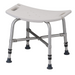 The Nova Medical Heavy Duty Bariatric Shower Chair is white and plastic with a curved design and drainage holes. It features four metal legs with adjustable heights, non-skid rubber tips, and handles on either side for added support.