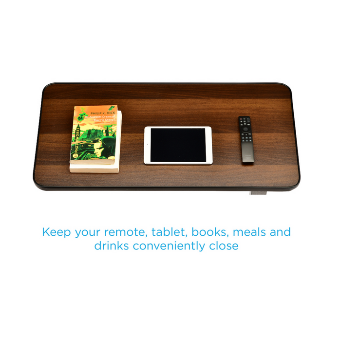 A Nova Medical Rolling Overbed Table - Non Tilt holds a book, tablet, and remote control on its wooden surface. Text below reads, Adjustable height keeps your remote, tablet, books, meals, and drinks conveniently close.