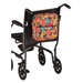 The Nova Medical Mobility Storage Bag, with a vibrant floral pattern, adorns the back of a sleek black transport wheelchair with four wheels and push handles, offering stylish storage for essentials.