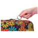 A hand holds a round keyring attached to a Nova Medical Mobility Storage Bag, featuring colorful floral and paisley designs on a sleek black background, perfect for walkers, rollators, wheelchairs, and scooters.