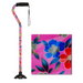 The Nova Medical Stand Alone SugarCane with Quad Tip features a colorful design of red, blue, and green flowers on a pink background. It includes a comfortable grip, black handle, and wrist strap. A close-up image highlights the vibrant floral details for enthusiasts.