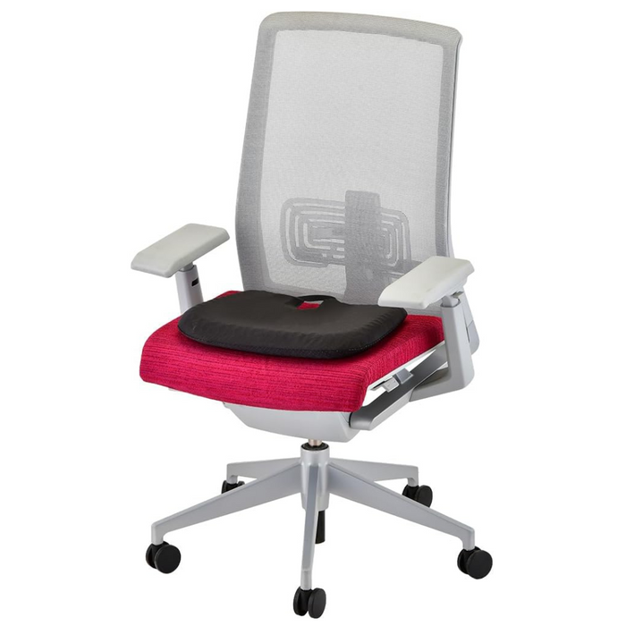 The Nova Medical Happy Collection chair offers a mesh backrest, gray adjustable armrests, and a vibrant pink seat cushion with a black lumbar support gel cushion. It features a swivel base and five black caster wheels for mobility and pressure relief.