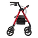 The Nova Medical Star 8 DX Heavy Duty Extra-Wide Bariatric Rollator, in red metal, features all-terrain wheels, an extra-wide padded seat, a black storage bag underneath, hand brakes, and ergonomic handles for mobility assistance.