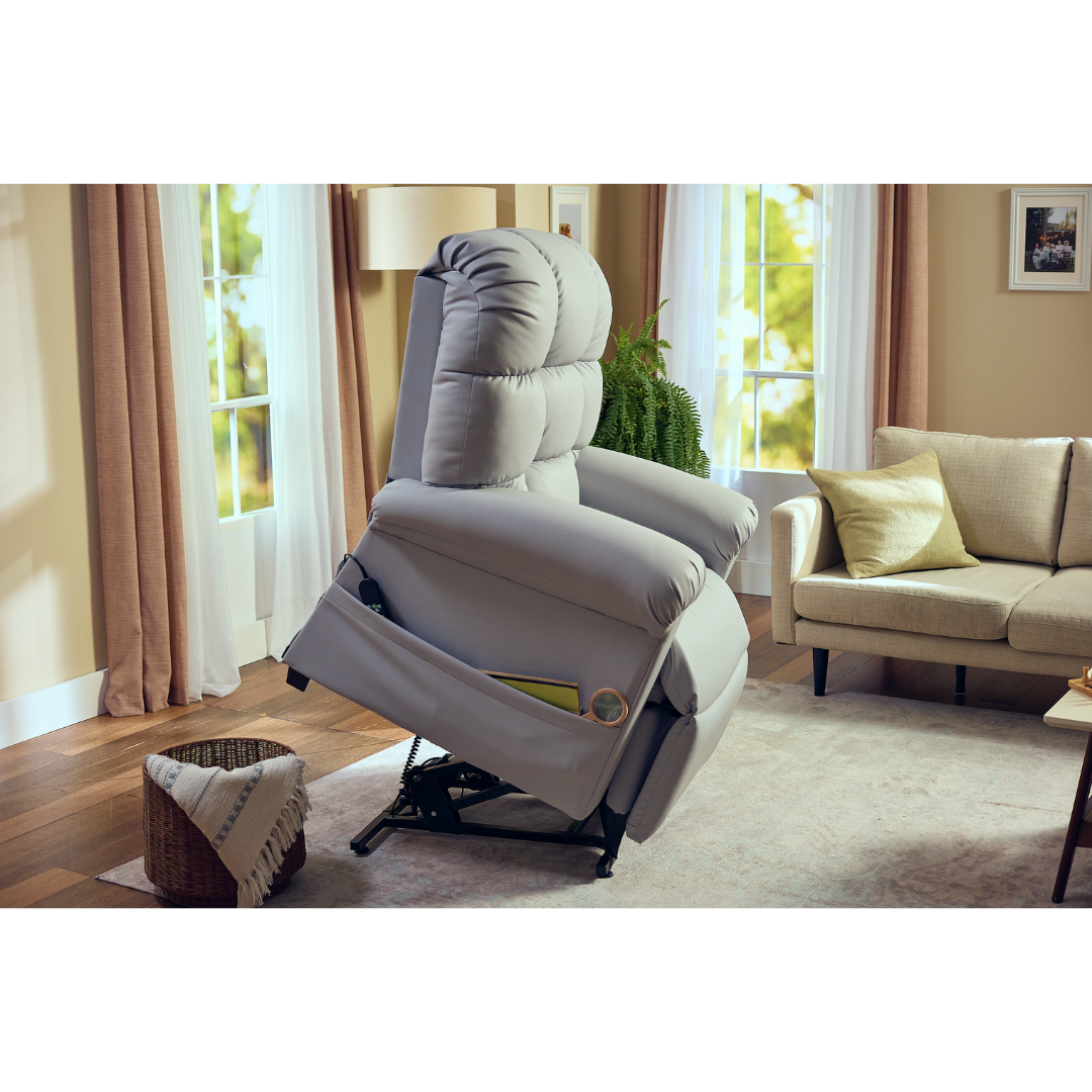 The Journey Perfect Sleep Reclining Lift Chair with Heat brings ultimate comfort to your living room with its therapeutic heat and massage features. Nestled on wooden floors, it complements white and beige curtains, a sofa with a throw pillow, and a basket with a blanket as greenery thrives outside the windows.