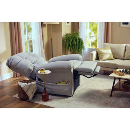 A cozy living room features the Journey Perfect Sleep Reclining Lift Chair with Heat for ultimate comfort, a small side table holding a drink, a basket with a blanket, and nearby plant. A chessboard sits on the coffee table as sunlight filters through the windows.