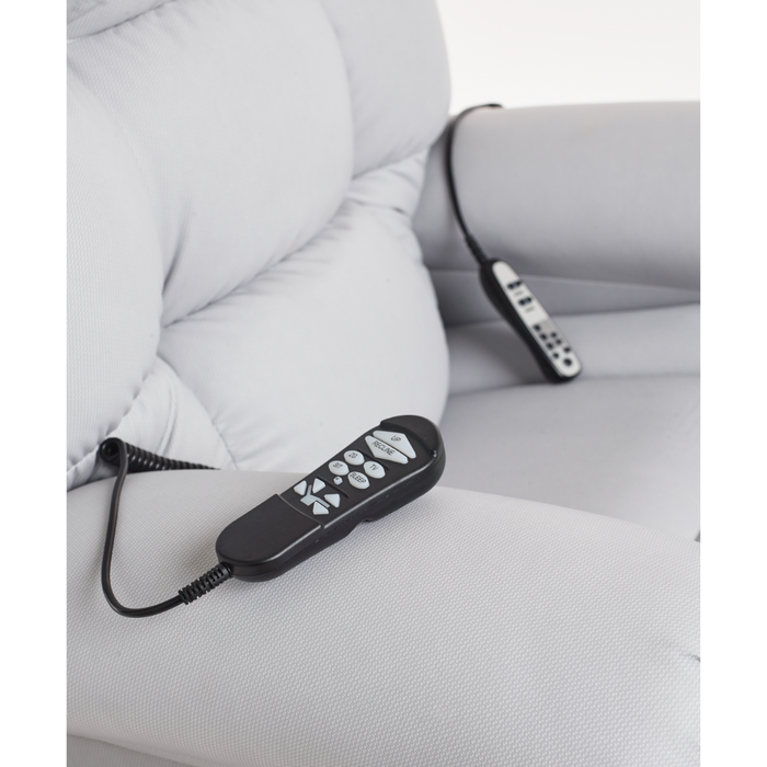 The Journey Perfect Sleep Recliner & Lift Chair with Heat in gray has two remote controls on coiled cables, each with multiple buttons to adjust the chairs position and enhance relaxation.