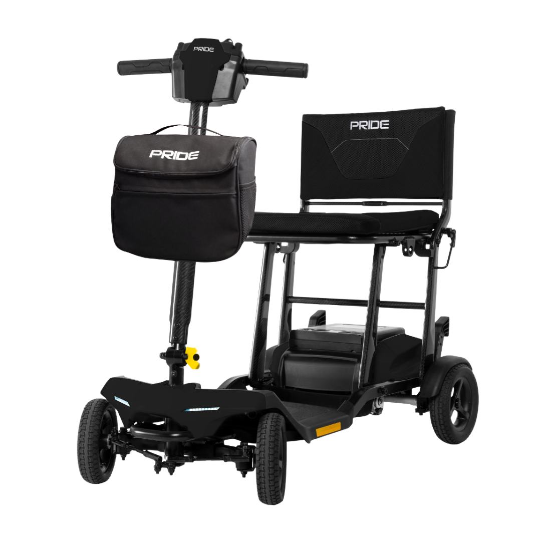The Pride Mobility Go Go® Super Portable Mobility Scooter is a black, four-wheel folding scooter with a front handlebar, attached storage bag, cushioned seat, and visible PRIDE branding on the bag, handlebar, and backrest. Compact for easy portability.