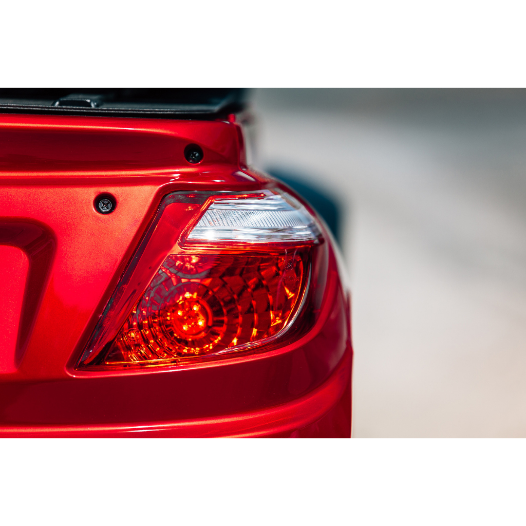 Close-up of the rear left tail light on the Pride Baja® Raptor® 2 Bariatric 4-Wheel Scooter, illuminated and highlighting the scooters premium design and outdoor mobility features against a softly blurred background.