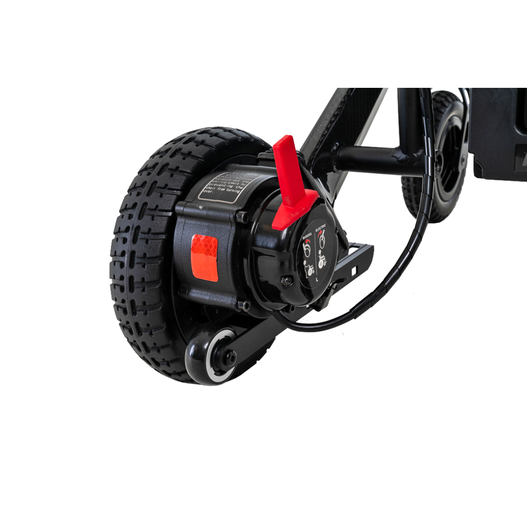 Close-up of a black powerchair wheel with motor, reminiscent of the sleek Jazzy Carbon. The textured tread has a red lever on the motor housing connected by black cables, and the ultralight frame of the Pride Mobility Jazzy® Carbon Ultralite Powerchair is partially visible.