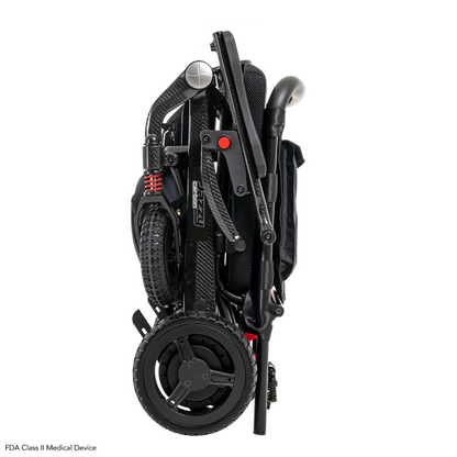 The Pride Mobility Jazzy® Carbon Ultralite Powerchair features a compact black design with large wheels and red suspension springs. It includes handles, footrests, a padded seat, and a removable joystick with USB charger. An airline-compliant lithium battery ensures convenient transport.