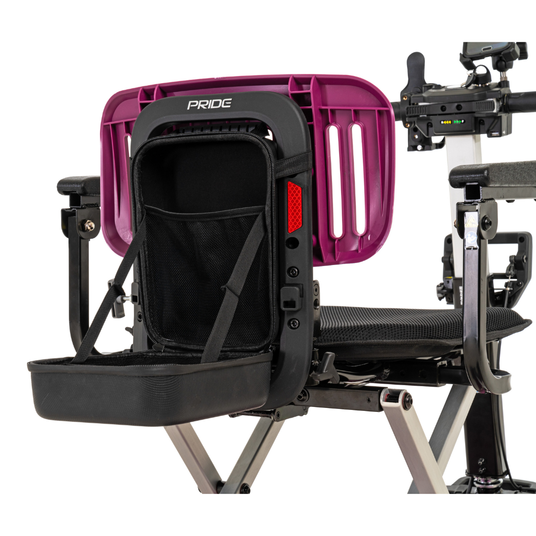 A close-up of the Pride Mobility i-Go™ Portable Travel Scooter shows a sleek, ultra-compact design with a purple backrest and a black storage pouch. It features a black frame and seat with feather-touch disassembly for easy handling, complemented by side electronic controls.