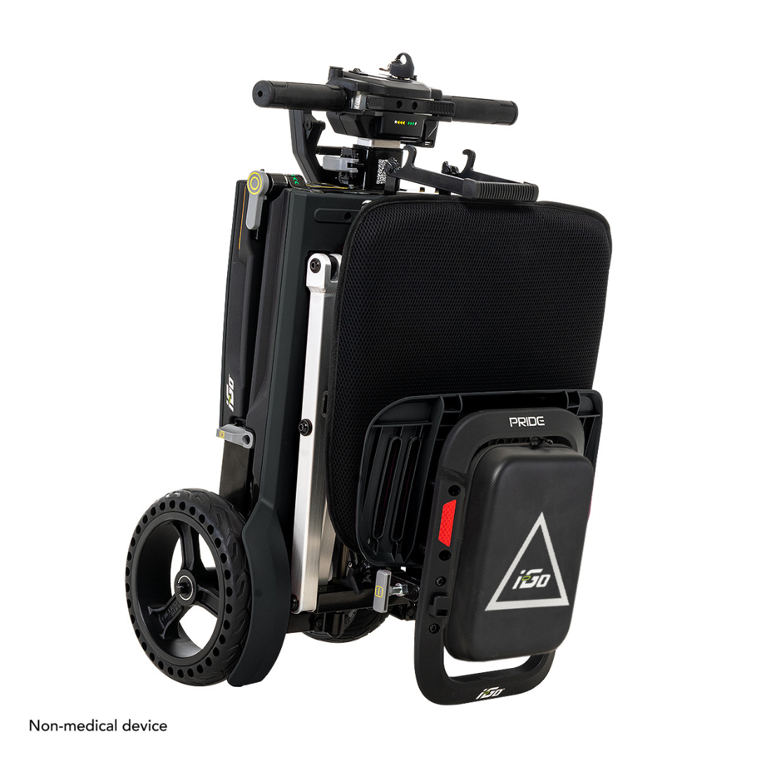 The Pride Mobility i-Go™ Portable Travel Scooter is a compact, black electric device designed for easy folding and transport. It features Feather-Touch Disassembly, a triangular logo on the back, sleek black wheels, and non-medical device inscribed on the bottom left.