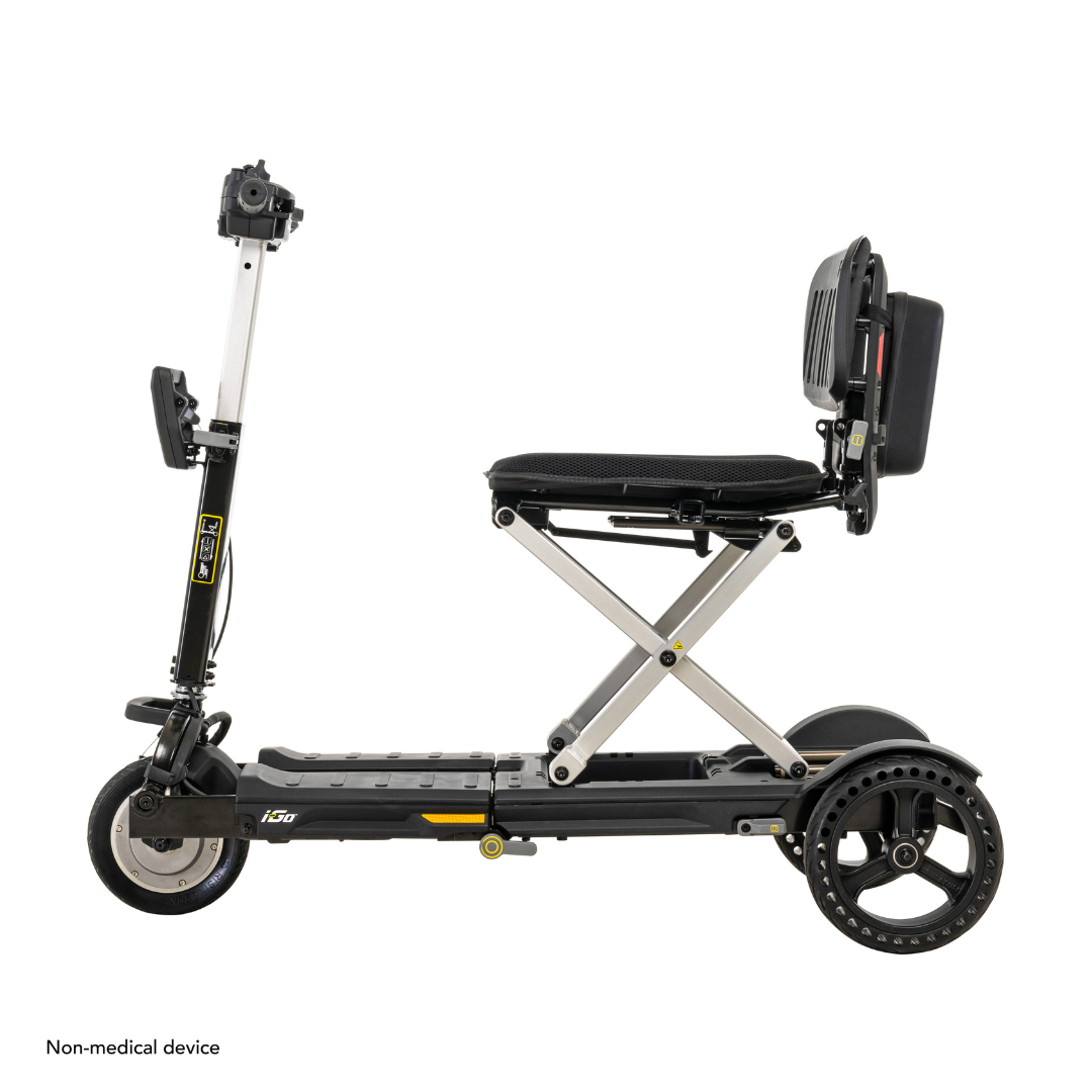 Explore the Pride Mobility i-Go™ Portable Travel Scooter: an ultra-compact, foldable design with Feather-Touch Disassembly. This black scooter with a silver frame features three wheels, a padded seat, sleek handlebars, and convenient small footrests.