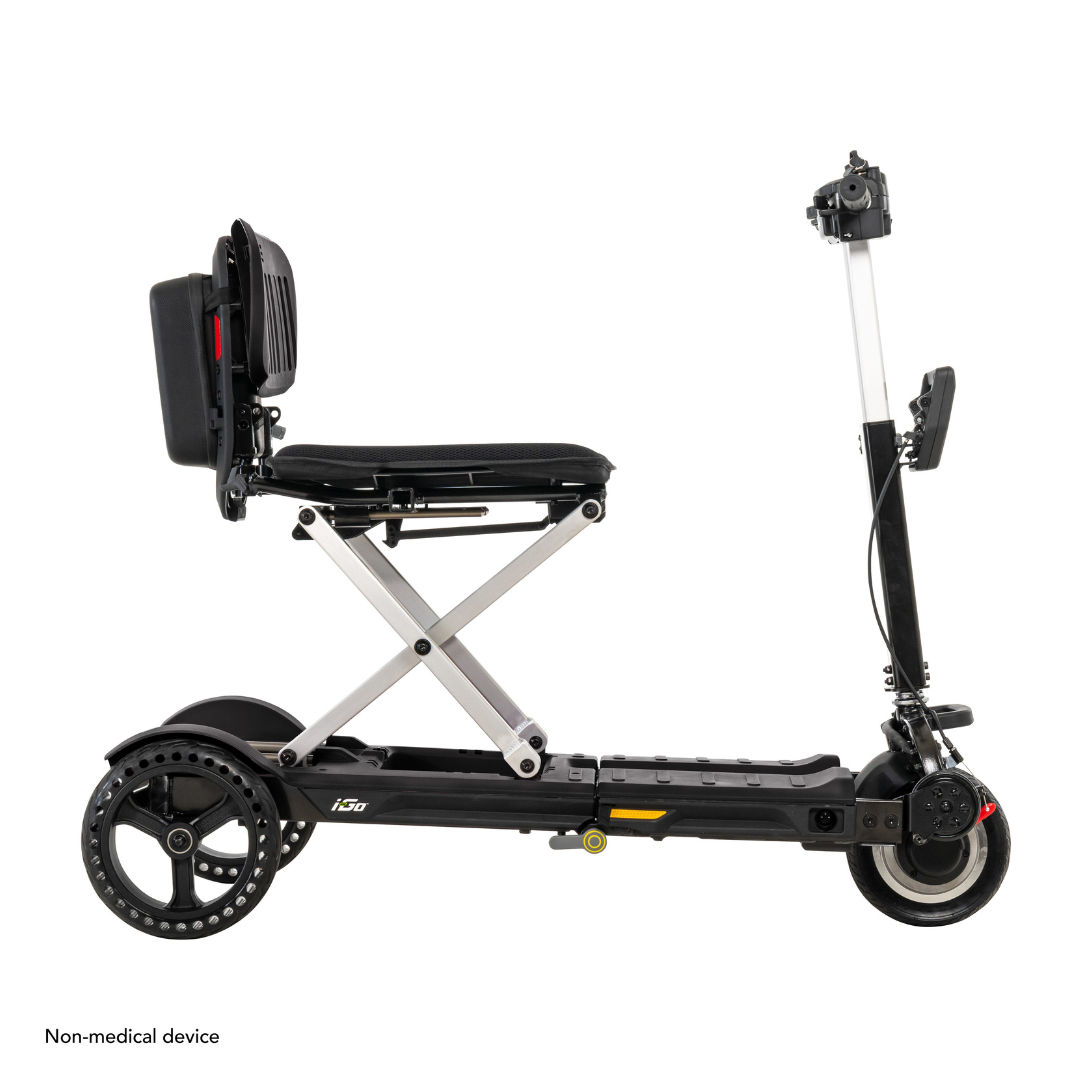 The Pride Mobility i-Go™ Portable Travel Scooter offers an ultra-compact design, padded seat with backrest, and lightweight metal frame and handlebars for easy transport. It features feather-touch disassembly for user convenience and is labeled as a Non-medical device.