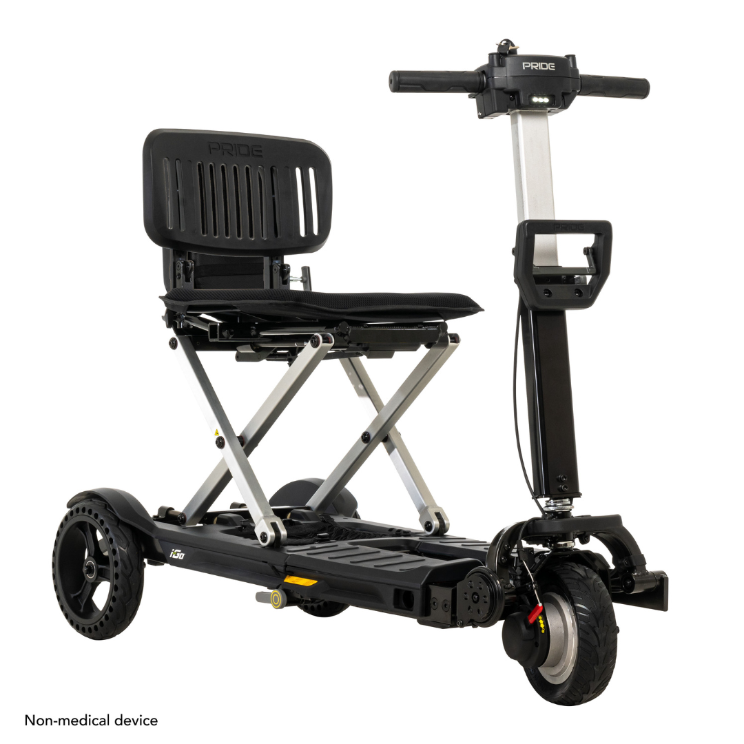The Pride Mobility i-Go™ Portable Travel Scooter features an ultra-compact design with a black seat, metallic frame, steering handle, three wheels, and footrest for easy transport. Non-medical device text is displayed at the bottom left.