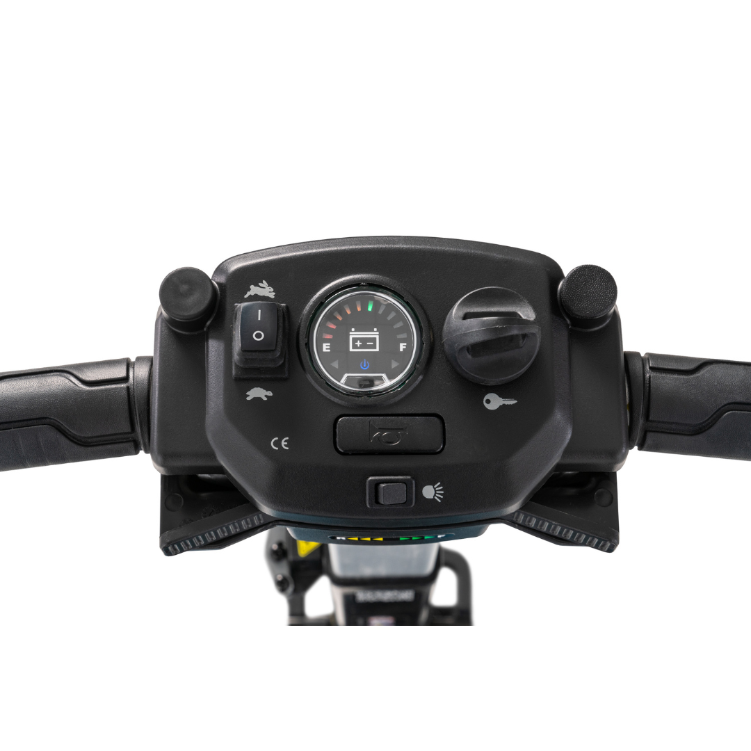 Close-up of the Pride Mobility i-Go™ Portable Travel Scooters handlebar control panel, featuring a speedometer, fuel gauge, ignition key slot, and switches. Black handlebars have textured grips, with symbols for lights and indicators displayed in an ultra-compact profile.