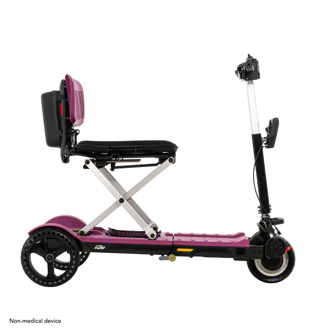 Side view of the purple Pride Mobility i-Go™ Portable Travel Scooter with black seat and handlebars. Features include a foldable seat with metal support bars, an ultra-compact profile, and three wheels in a portable design labeled as a non-medical device.