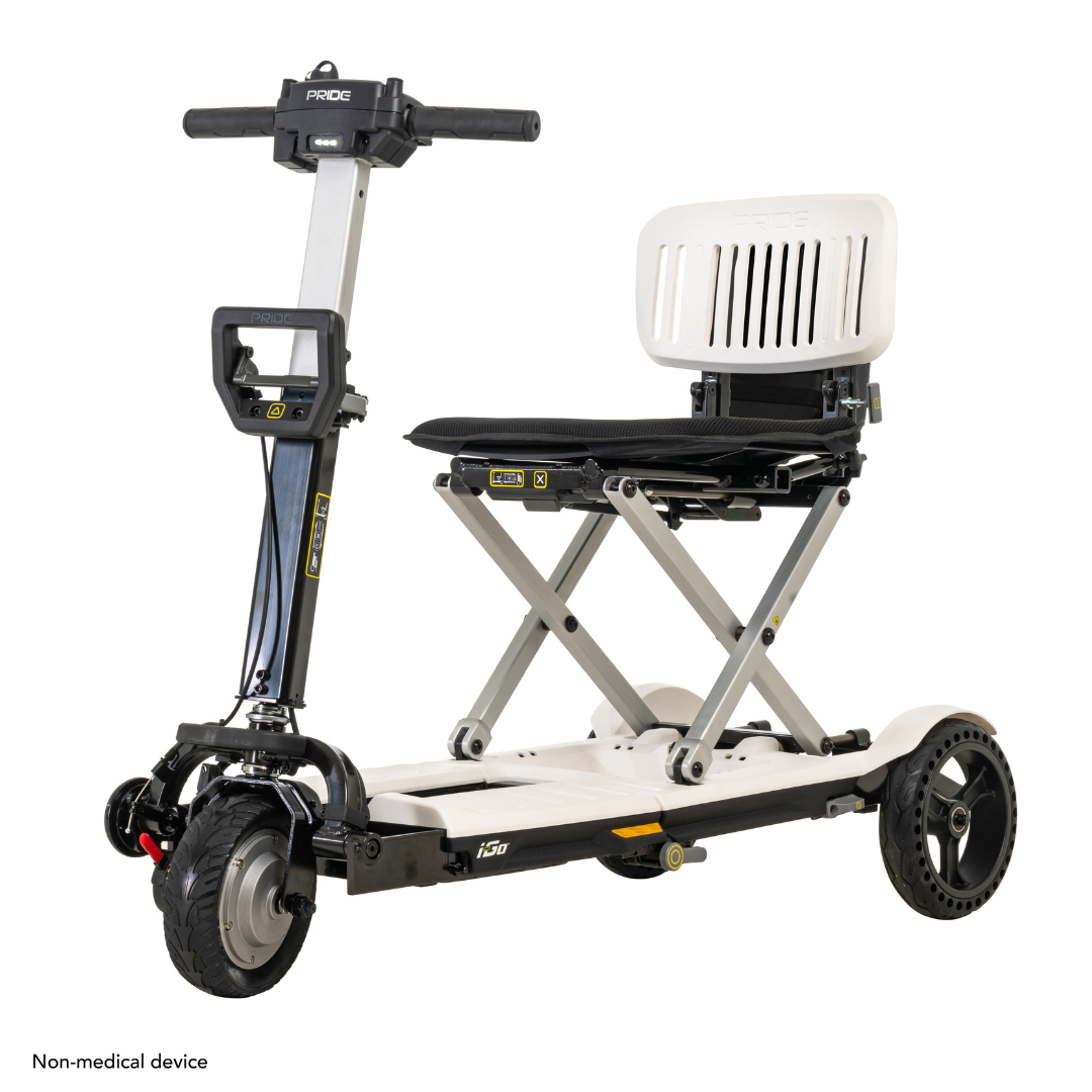 The Pride Mobility i-Go™ Portable Travel Scooter features a white seat with black accents, an ultra-compact design, feather-touch disassembly, four wheels, and adjustable handlebars. Its lightweight frame ensures easy transport and maneuverability.