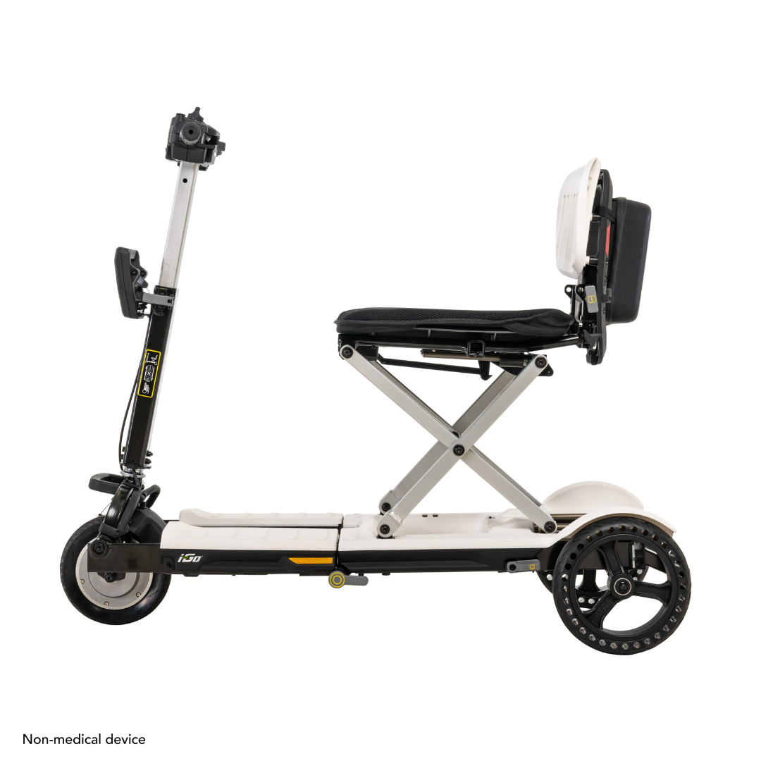 The Pride Mobility i-Go™ Portable Travel Scooter is ultra-compact and foldable with three wheels. Its sleek white frame, elevated black seat, upright handlebar, and larger rear wheels provide stability. Its a non-medical device featuring feather-touch disassembly.