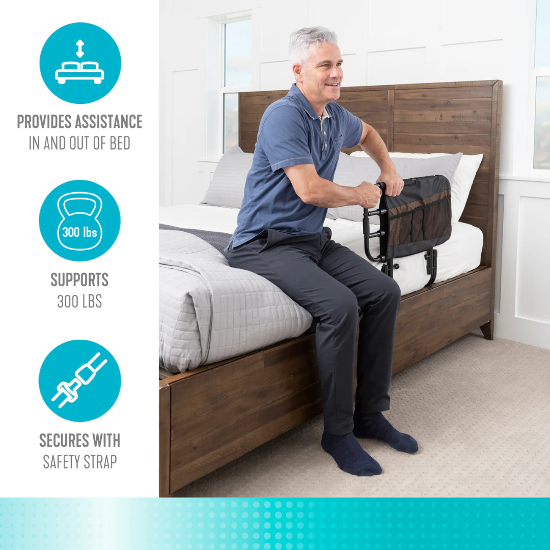 A man sits on a bed holding the Stander EZ Adjust Bed Rail. Text beside him says: Assists in and out of bed, supports up to 300 lbs, and secures with a safety strap, featuring icons for added fall protection.