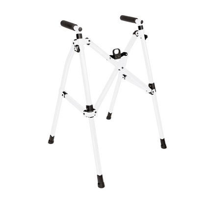 The Stander Wonder Walker Lite is a compact, foldable white metal walker with four legs, black rubber feet, and handle grips, designed for lightweight support and easy transport.