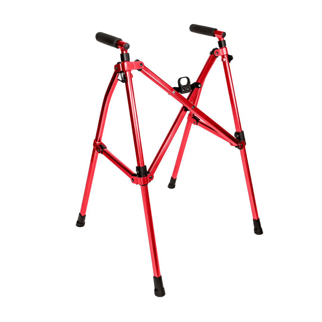 The Stander Wonder Walker Lite is a red, foldable metal stand with black rubber feet and handles, shown upright on a white background. Its compact design makes it easy to store and portable, resembling a folding walker.