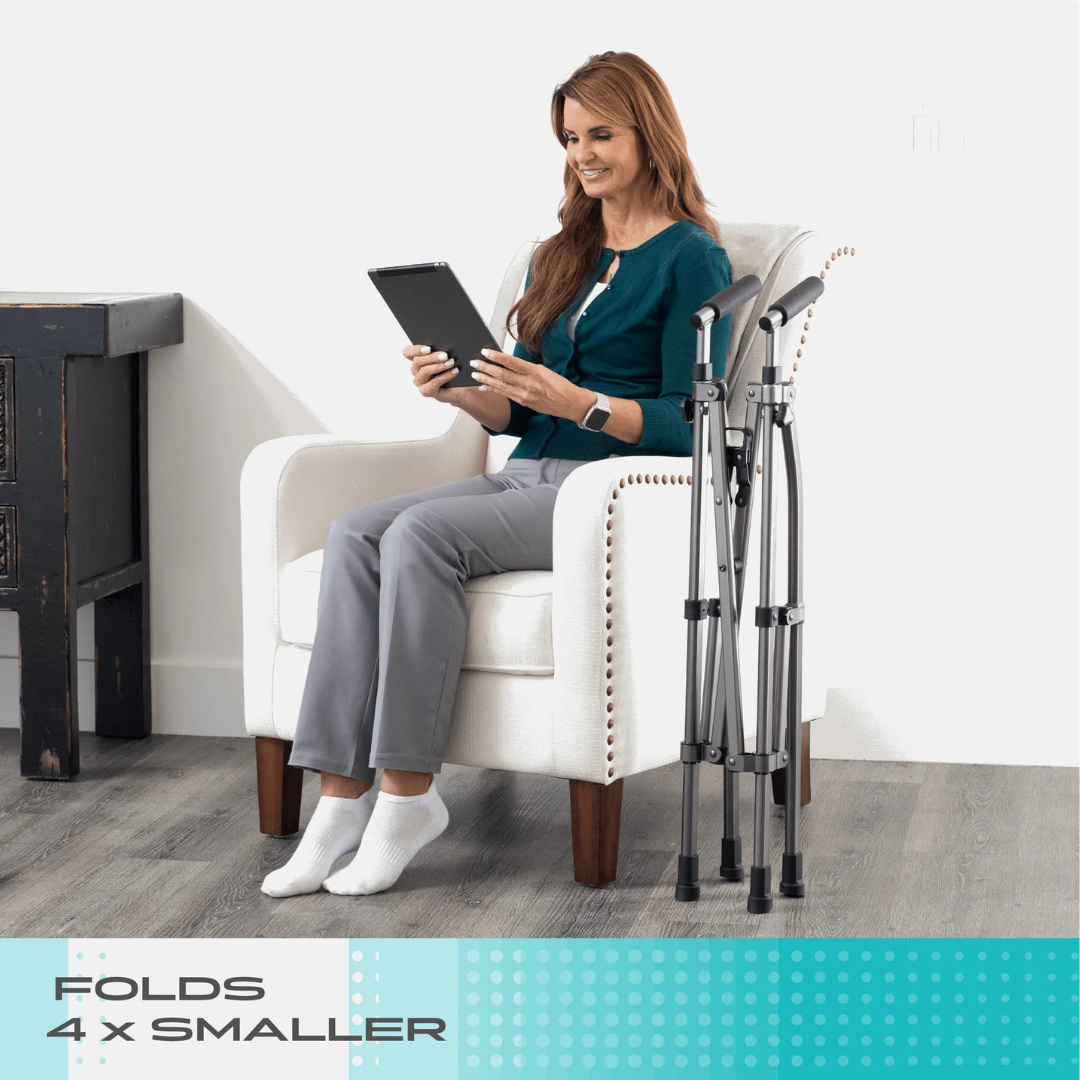 A woman sits in a white armchair holding a tablet, with the Stander Wonder Walker Lite—a compact folding walker—beside her. Text on the image reads, FOLDS 4x SMALLER.