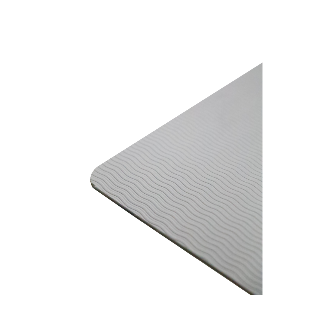 Close-up of the corner of the Step2bed Deluxe Bedside Step-Up Platform, rectangular and light gray with a subtle wavy textured pattern. Plain white background. Includes accessory kit.