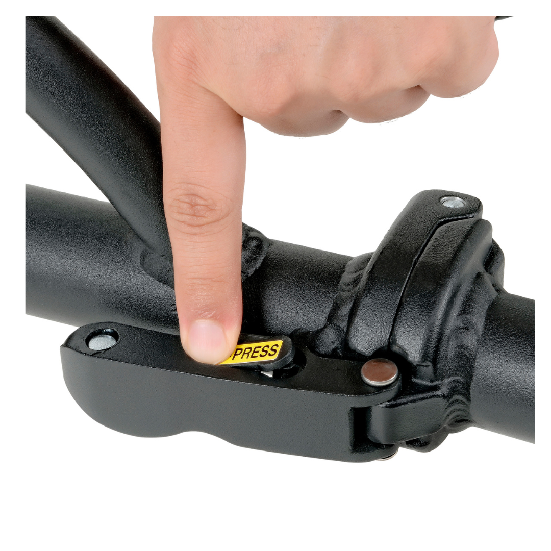 A close-up of a persons hand pressing a yellow PRESS button on the black mechanism of the SuperHandy Passport Power Mobility 3-Wheel Scooter, weighing only 35 lbs. The mechanism, secured with screws to a metal bar, seems integral to its foldable design.