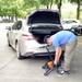 Man folding the SuperHandy Passport Power Mobility 3-Wheel Scooter and placing it in his trunk