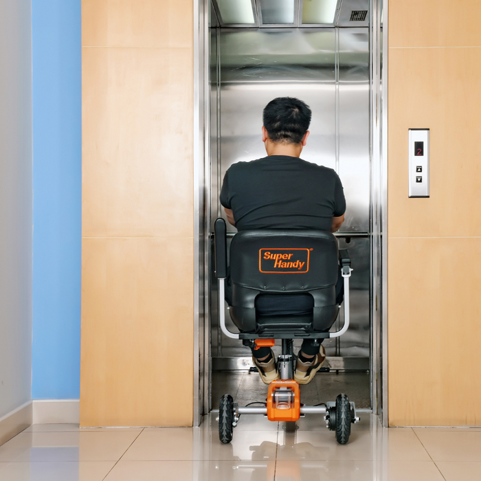 man entering an elevator with the SuperHandy Passport Plus Portable Power Mobility Scooter GUT140