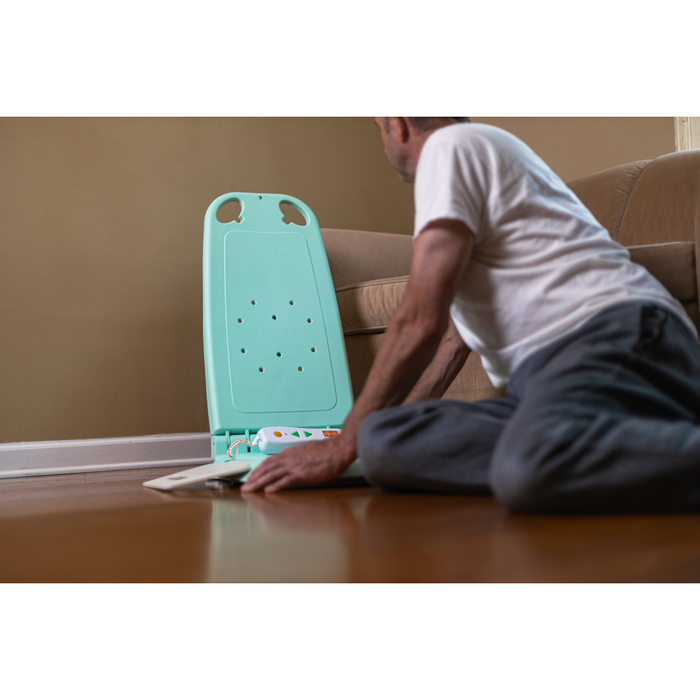 Man on the ground reaching for the SuperHandy GoRise LT Portable Waterproof Floor Lift