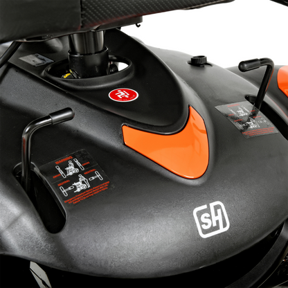 A close-up of a black and orange control panel from the SuperHandy GoRide CRX Powerchair, showcasing levers, a red circular button, and an SH logo.