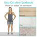 A woman in workout attire smiles next to text stating Use On Any Surface with icons for Wood, Tile, and Carpet. The Vive Health XL Bedside Padded Fall Mat features a non-slip design, ideal for those with mobility challenges or anyone needing extra stability.