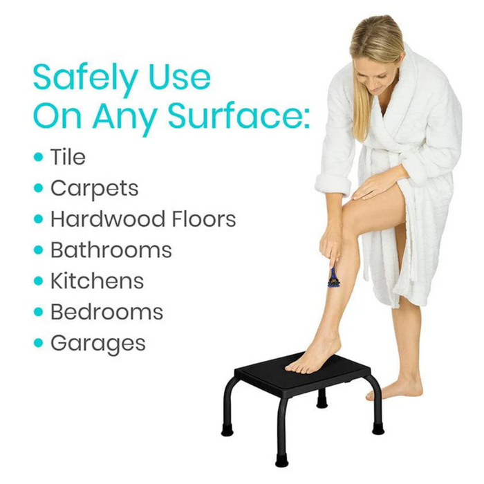 A person in a white robe uses the Vive Health Step Stool with a non-slip platform to shave their leg. Suitable for tiles, carpets, hardwood floors, bathrooms, kitchens, bedrooms, and garages.