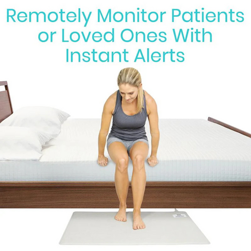 A person in athletic wear sits on the edge of a bed with a white mattress, which is above the Vive Health Wireless Floor Alarm Mat & Transmitter for patient monitoring. Text reads, Remotely Monitor Patients or Loved Ones With Instant, Real-Time Alerts.