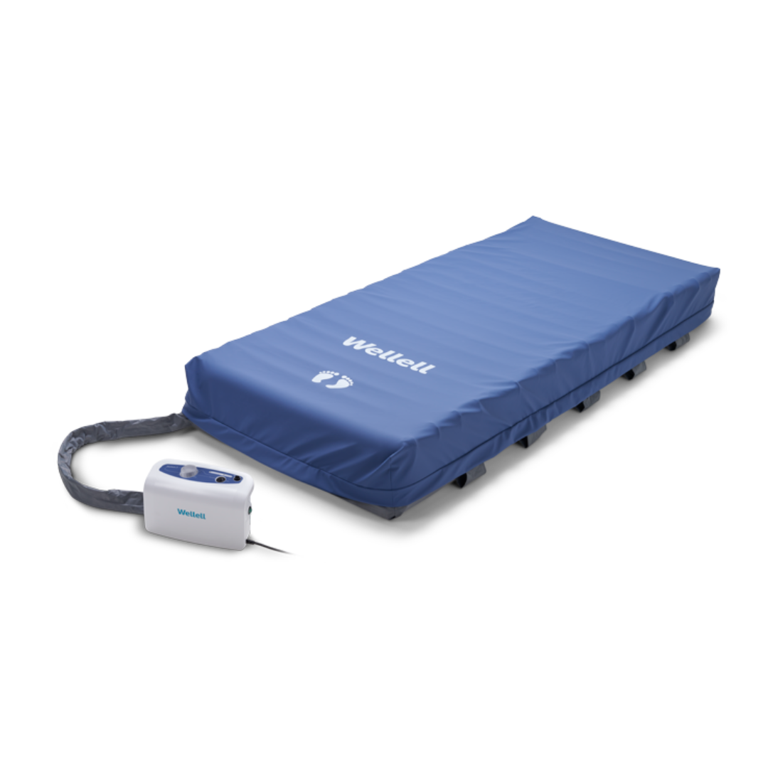The Wellell Domus 3 Bariatric Alternating Pressure Mattress with Micro Low Air Loss offers pressure ulcer prevention with an alternating pressure system and hose-connected control unit, ideal for long-term care on a white background.