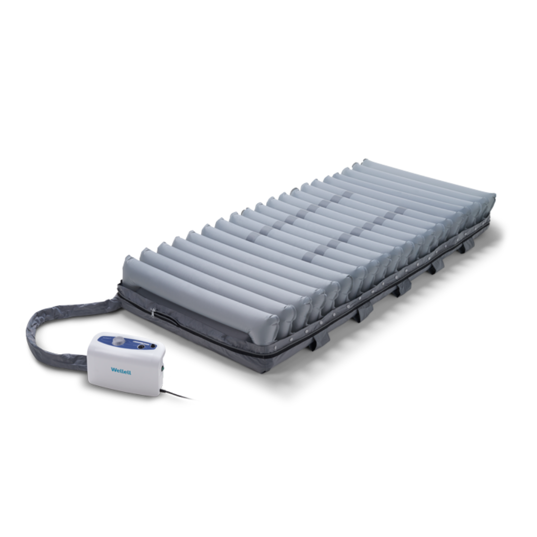 The Wellell Domus 3 Bariatric Alternating Pressure Mattress with Micro Low Air Loss, designed for pressure ulcer prevention and long-term care, features multiple horizontal air chambers and an attached pump unit. Displayed on a white background.